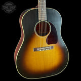 Acoustic guitar with a sunburst finish on a black background, featuring the Tone Shop logo.