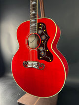 Red acoustic guitar with a dark gray background