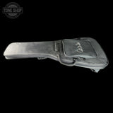 A dark gray guitar headstock hard case with a front zippered pocket featuring a white script logo, shown against a solid black background.