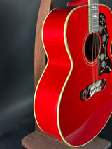Red acoustic guitar on a black background