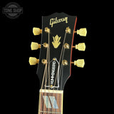 Gibson guitar headstock with brand logo on a black background