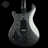 The back of a Deerranger electric guitar with a textured black and silver finish, shown against a solid black background. The Tone Shop logo is visible in the top-left corner.