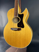 Acoustic guitar with a wooden finish on a dark background