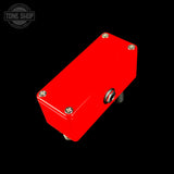Red guitar effects pedal with visible branding on a black background