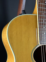 Close-up of a wooden acoustic guitar on a black background