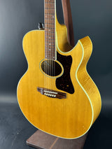 Acoustic guitar with a wooden finish on a dark background