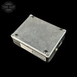 Metallic electronic device on a black background with 'Tone Shop' branding.