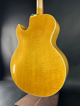 Gold electric guitar on a dark background