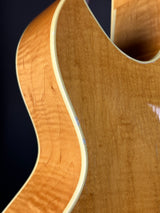 Close-up of a guitar's wooden body with a focus on the grain and texture.