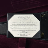 Certificate of authenticity for a Martin guitar on a dark background