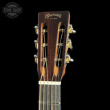 Close-up of a Martin guitar headstock on a black background