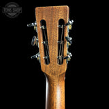 Close-up of a guitar headstock with a dark background