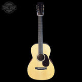 Acoustic guitar on a black background with 'Tone Shop' logo.