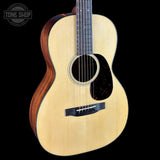 Acoustic guitar with a visible brand logo on a black background