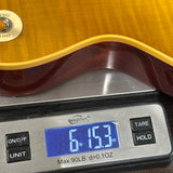 Gibson Custom Dealer Select 1959 Les Paul Chambered Lemon Burst AAA Top Ultra Light Aged on scale displaying weight.