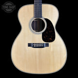 Acoustic guitar with a visible brand logo in the corner