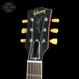 Gibson Les Paul guitar headstock with brand logo on a black background