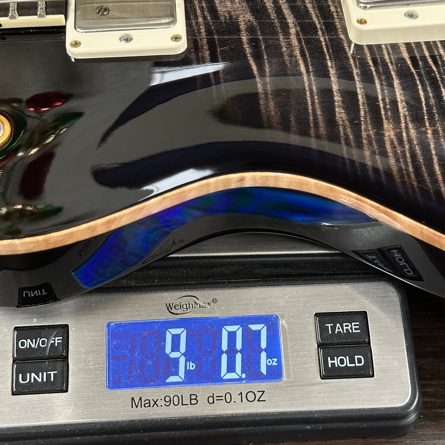 Guitar on a digital scale displaying weight