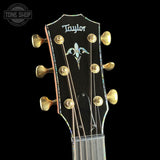 Taylor guitar headstock with gold tuning pegs on a black background