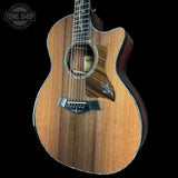 Acoustic guitar with a visible brand logo on a black background
