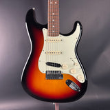 Electric guitar with a sunburst finish on a dark background