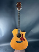 Acoustic guitar on a reflective gray surface