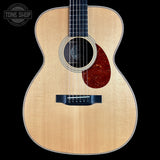 Acoustic guitar with a visible brand logo in the corner