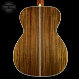 Wooden acoustic guitar back with 'Tone Shop' logo in the corner