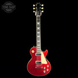 A red Gibson electric guitar with a cream pickguard and gold hardware, shown vertically against a solid black background. A 'TONE SHOP' watermark is visible in the top-left corner.