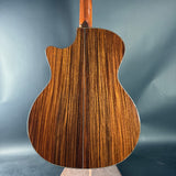 Wooden acoustic guitar body on a gray background