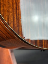 Close-up of a wooden guitar with a reflective surface