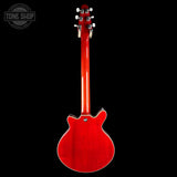 Red electric guitar on a black background with 'Tone Shop' logo.