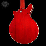 Red electric guitar body with a visible brand logo in the corner.