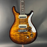 Electric guitar with a sunburst finish on a gray background