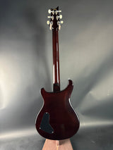 Glossy brown electric guitar on a gray background