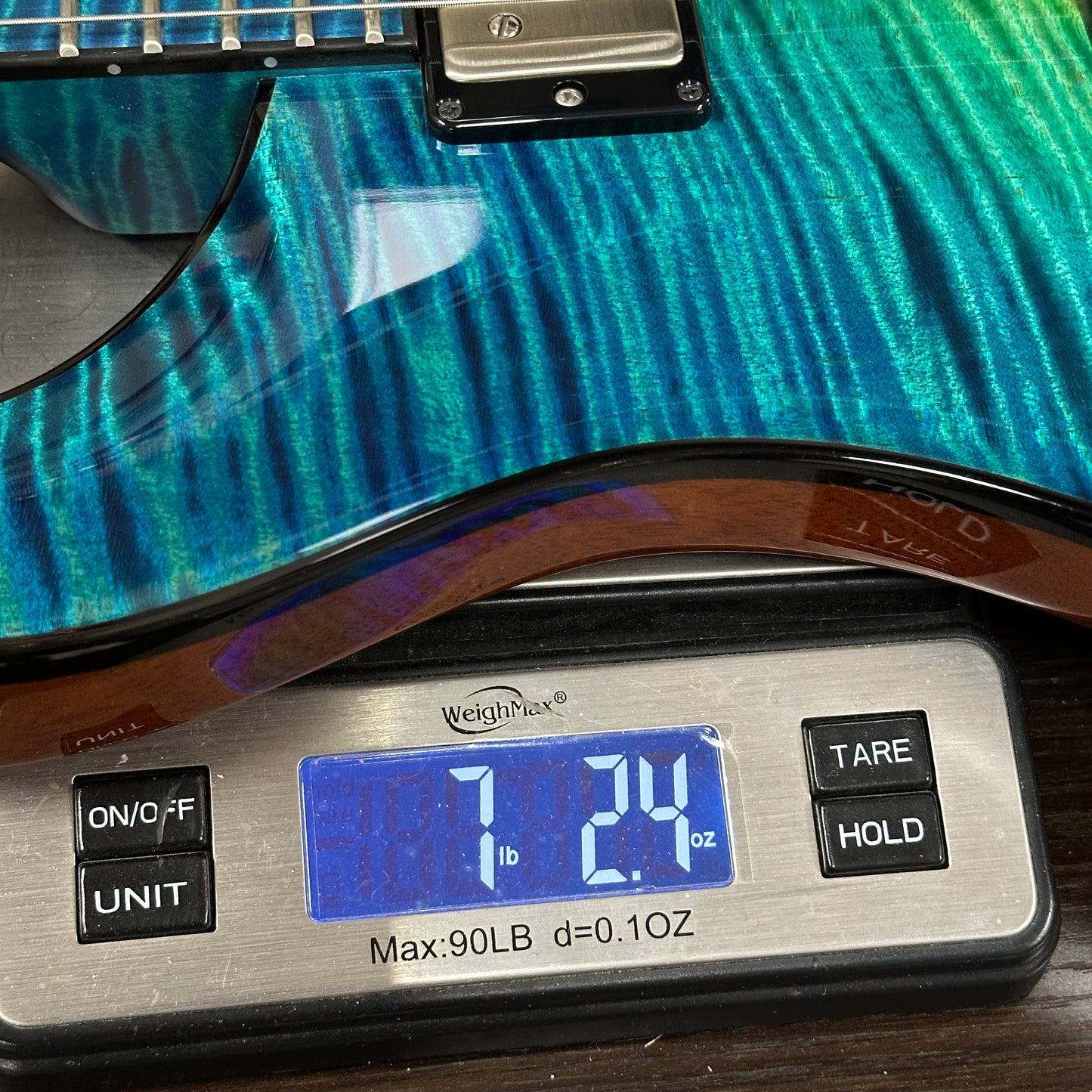 Guitar on a digital scale displaying weight