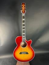 Acoustic guitar with a sunburst finish on a dark gray background