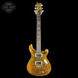 A Prichard electric guitar with a vibrant tiger-eye flame finish, shown from the front against a solid black background. The guitar features a natural wood neck and headstock, dual humbucker pickups, and a white pickguard.
