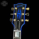 Gibson guitar headstock with blue logo on a black background