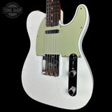 A white electric guitar with a light green pickguard and dark fretboard, shown against a solid black background. A Tone Shop watermark is visible in the top-left corner.