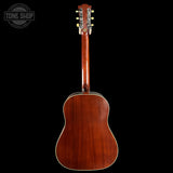 Back view of a wooden acoustic guitar on a black background with 'Tone Shop' logo.