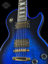 Blue electric guitar with a close-up of the neck and body on a black background