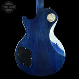 Blue electric guitar with Gibson logo on a black background