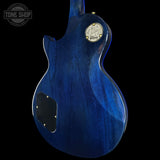 Blue electric guitar with Gibson logo on a black background