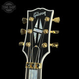Gibson guitar headstock with brand logo on a black background