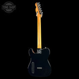 A black electric guitar with a natural maple neck, shown from the back against a solid black background. A 'TONE SHOP' watermark is visible in the top-left corner.
