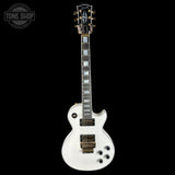 White electric guitar with a black pickguard on a white background, featuring the 'Tone Shop' logo.