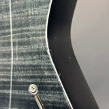Close-up of a screwdriver with a screw on a textured surface