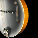 Close-up of an electric guitar body showing a matte black front, f-hole cutout, silver bridge, and a natural wood rim against a black background.