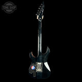 Black electric guitar on a black background with 'Tone Shop' logo.